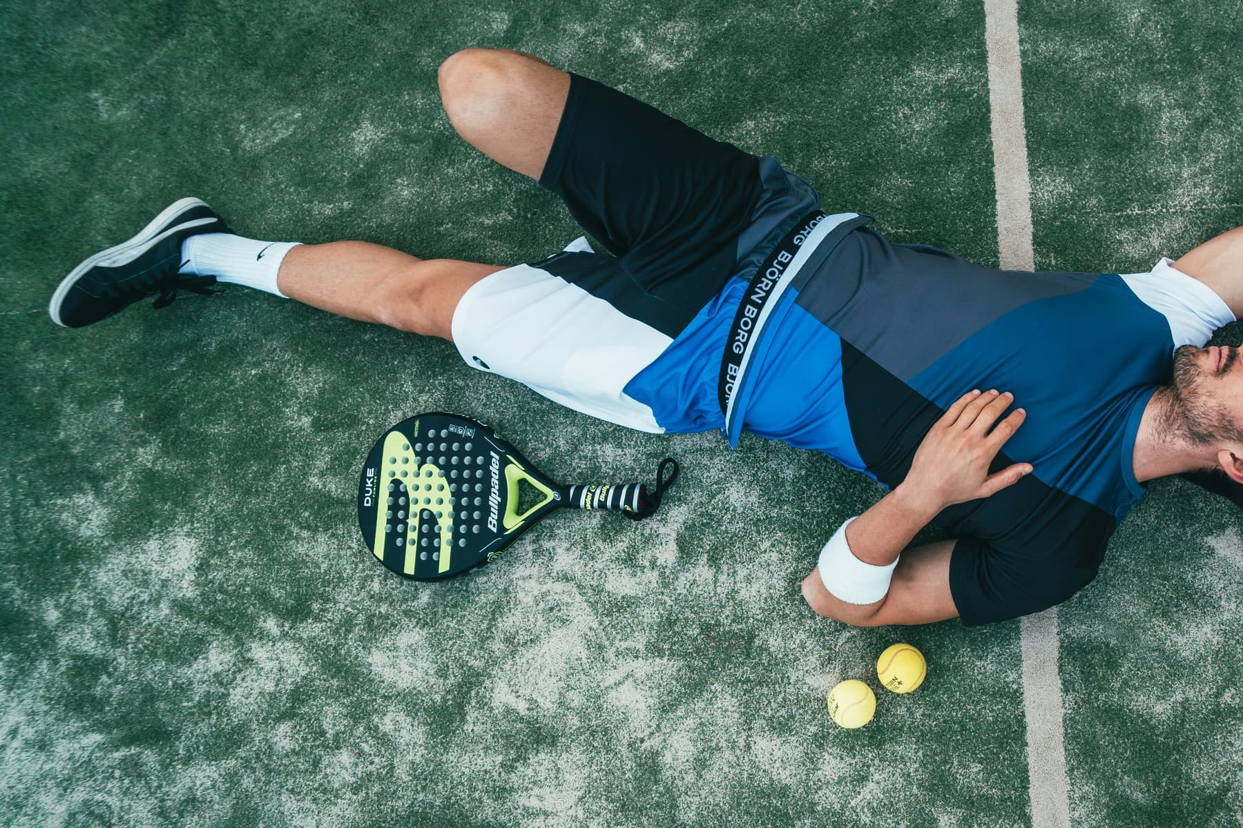 Padel players rallying at an indoor court